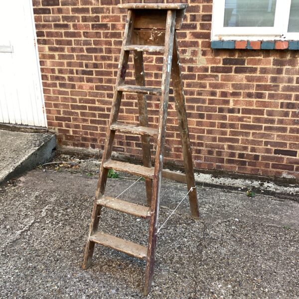 Vintage wooden step ladder with four steps, rustic farmhouse style.