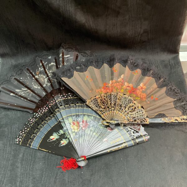Lot of three vintage hand fans with painted designs.