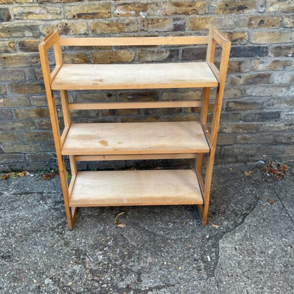 Vintage wooden foldable bookcase for portable storage.
