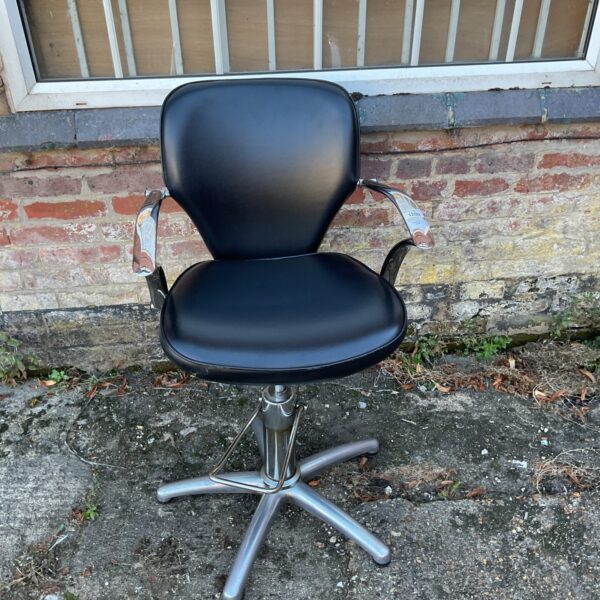 Black hydraulic barber chair for salon or home use.
