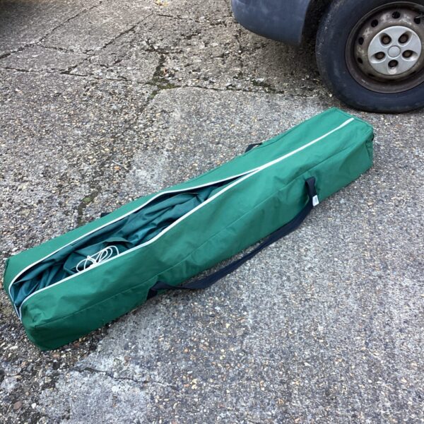 Green garden gazebo carry bag showing signs of use.