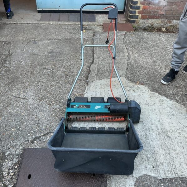 Vintage Black and Decker lawn rake for collecting leaves and garden debris.