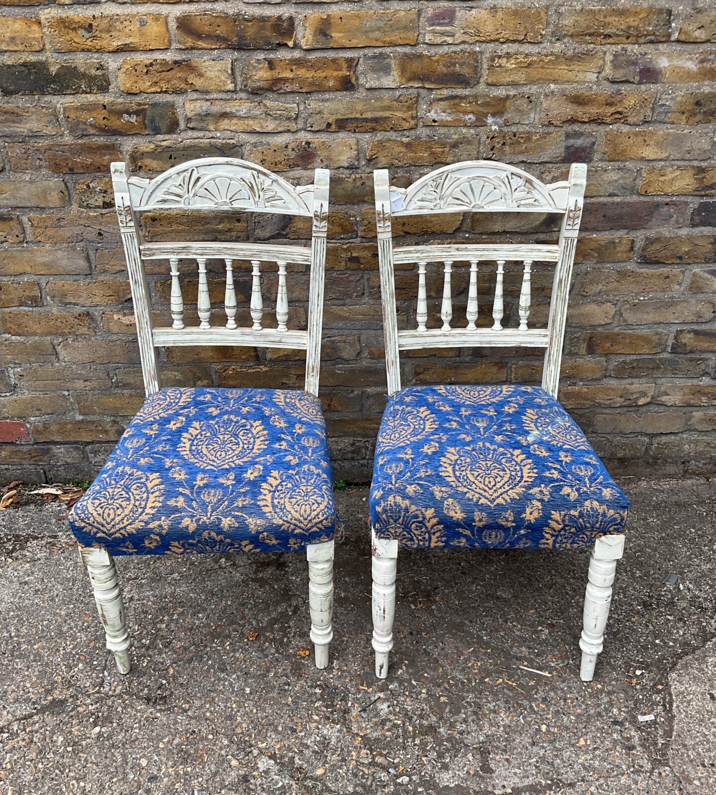 Pair of white spindle backed shabby chic chairs with blue and gold fabric seat