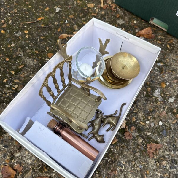 Vintage brass rocking chair and candle holders in a lot.