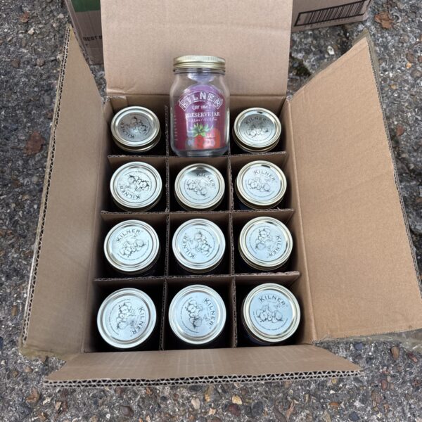 Box of new Kilner 0.5 litre preserve jars for kitchen storage.