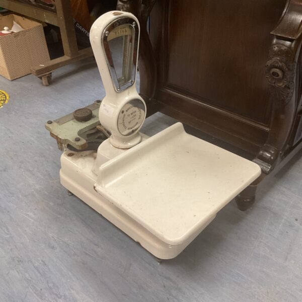Cream vintage shop scales with balance beam mechanism.