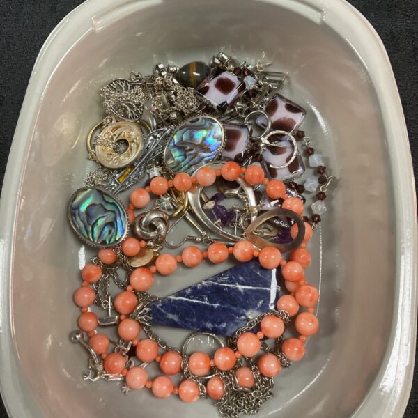 Tray of mixed vintage costume jewellery including necklaces and brooches.