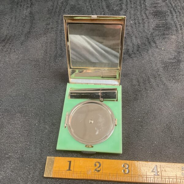 Open vintage Yardley art deco compact showing mirror and powder well.