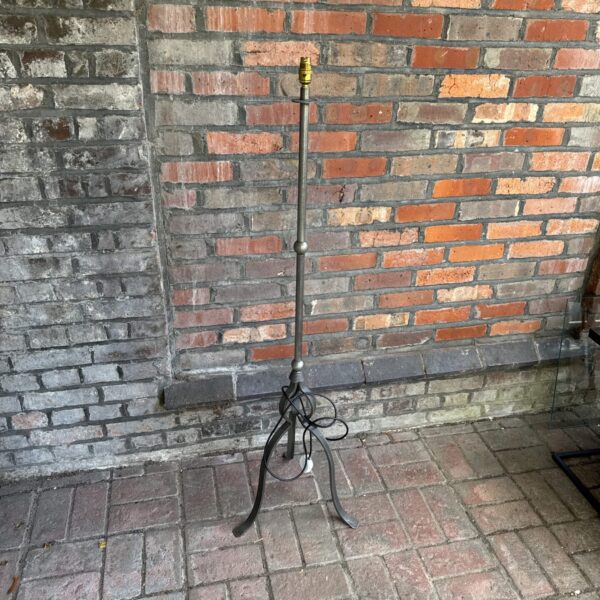 Vintage metal floor lamp with tripod base for home decor.