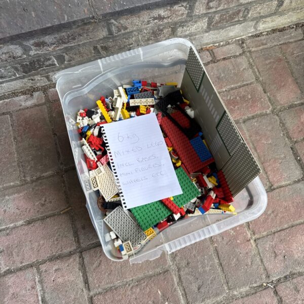 Mixed LEGO bricks lot with minifigures and baseplates.