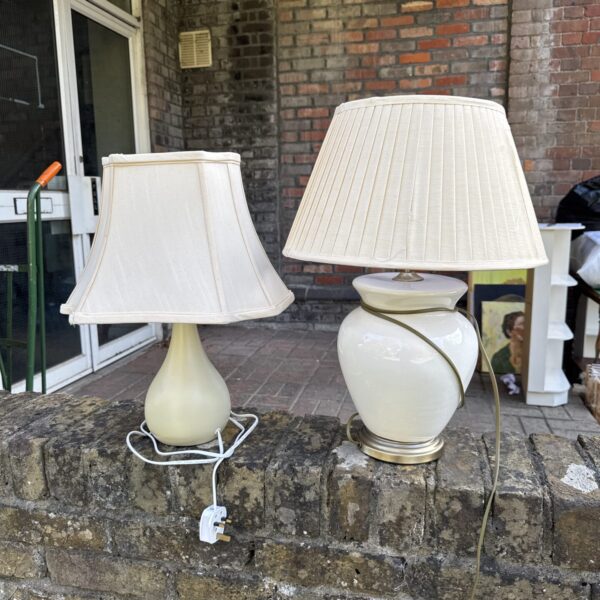 Vintage table lamp pair with ceramic bases and pleated shades.