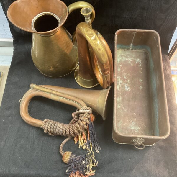 Antique copper collection featuring a bugle, jug, and planter.