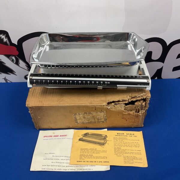 Vintage Spillers beam scales displayed at auction with weights.