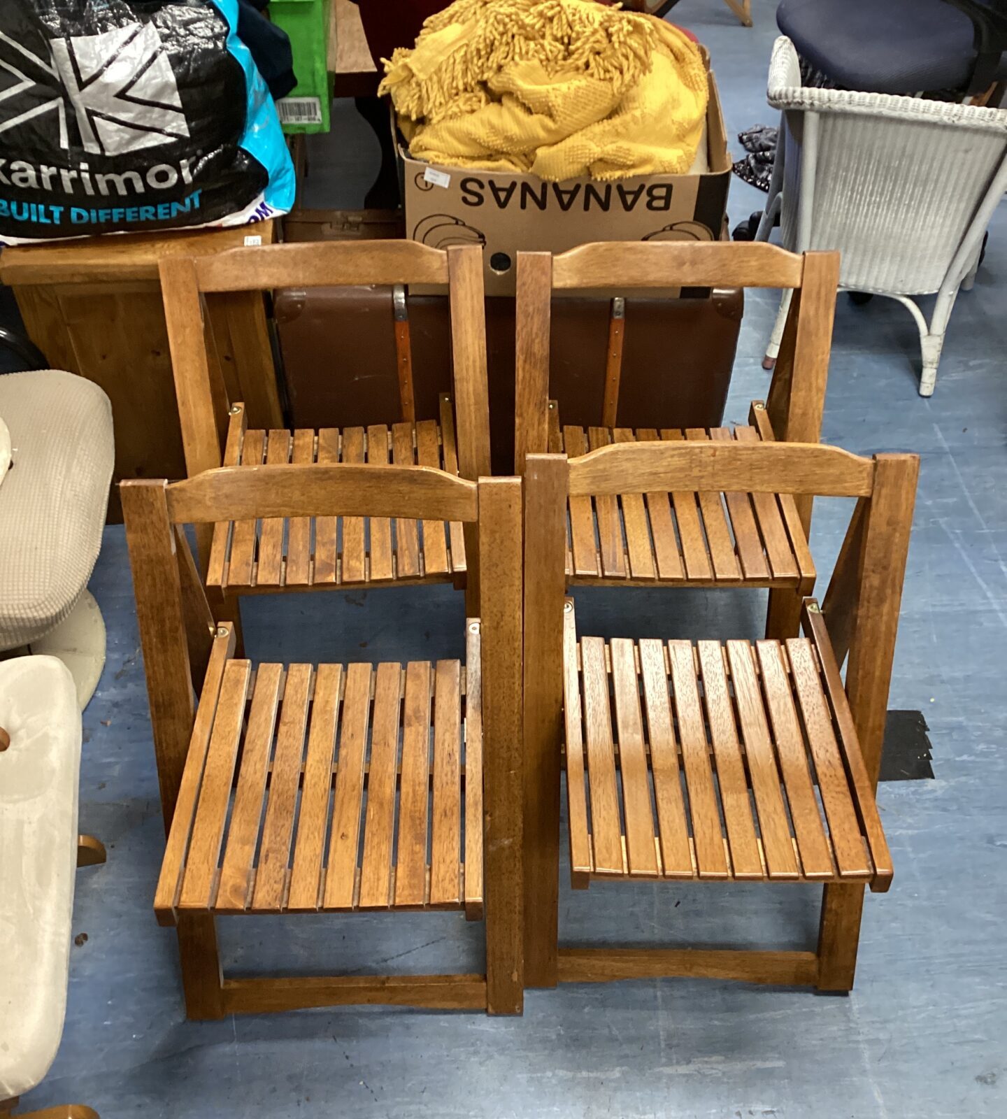 Four folding wooden chairs