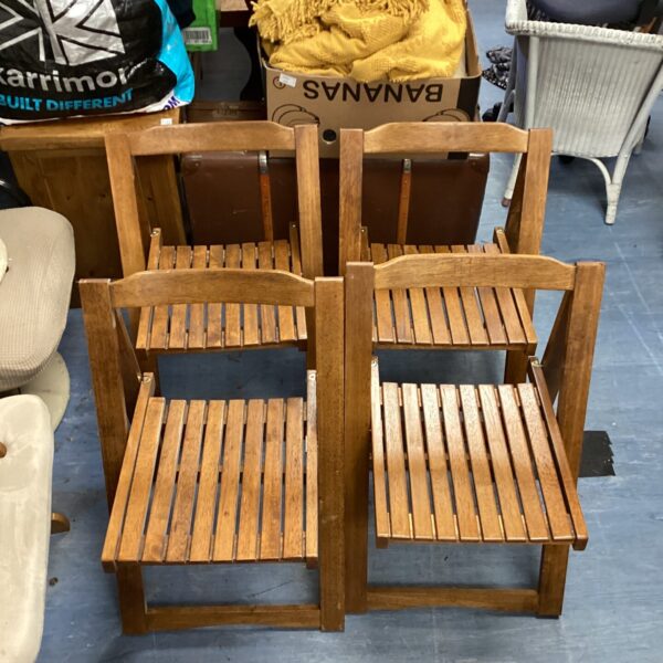 Four folding wooden chairs