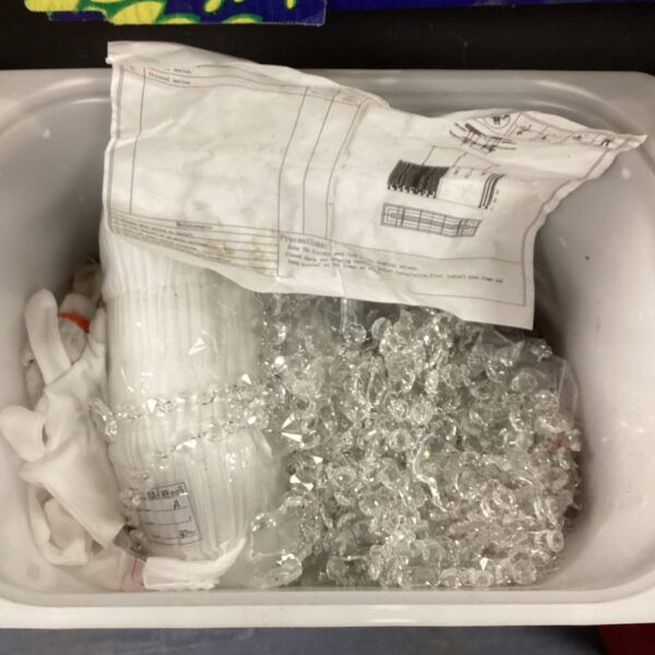 Large lot of clear chandelier crystals in a plastic tub.