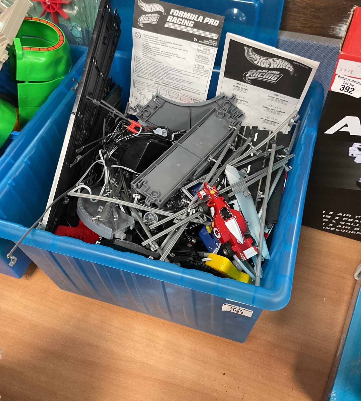 Box containing hotwheels forumla pro racing track sets and vehicles