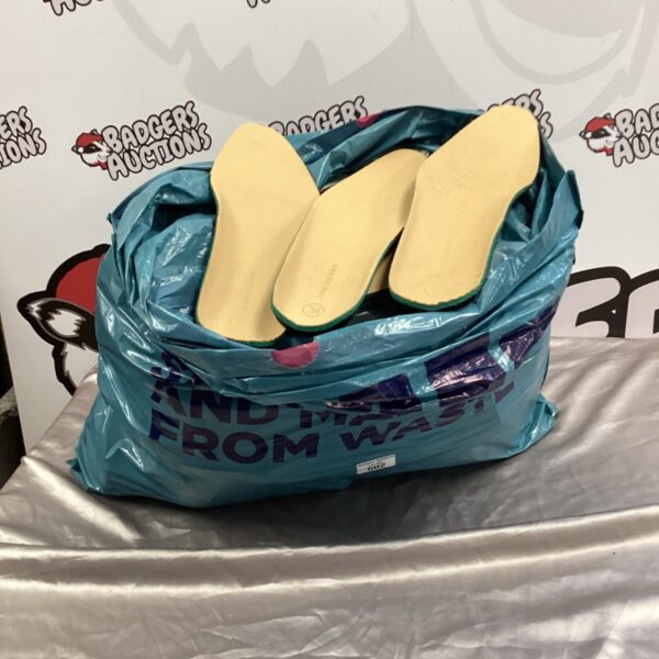 Bag of multiple shoe insoles for comfort and support.