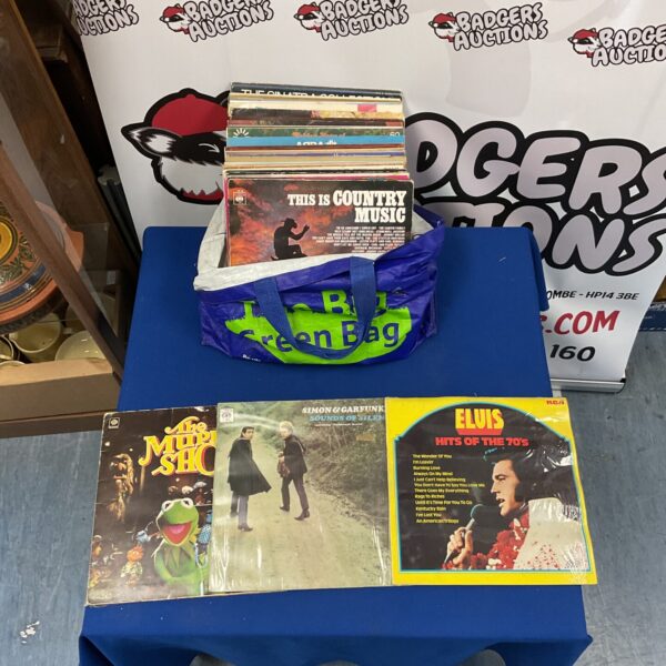 Vintage vinyl record collection featuring Elvis, Simon & Garfunkel, and The Muppet Show.