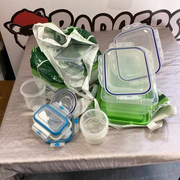 Translucent plastic storage tubs with lids in a lot.