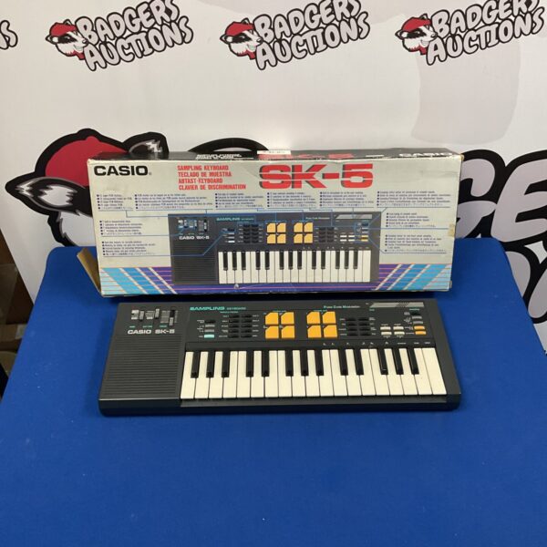 Vintage Casio SK-5 sampling keyboard with drum machine and retro design.