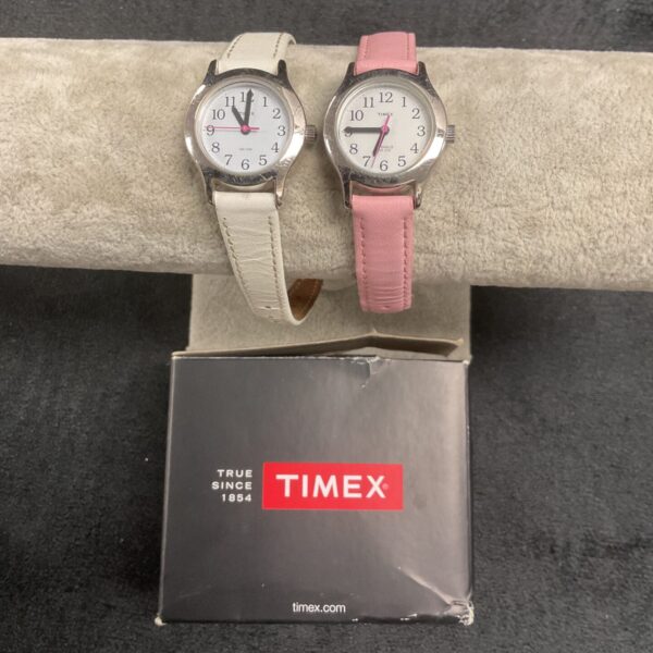Pair of vintage ladies Timex wristwatches on display.