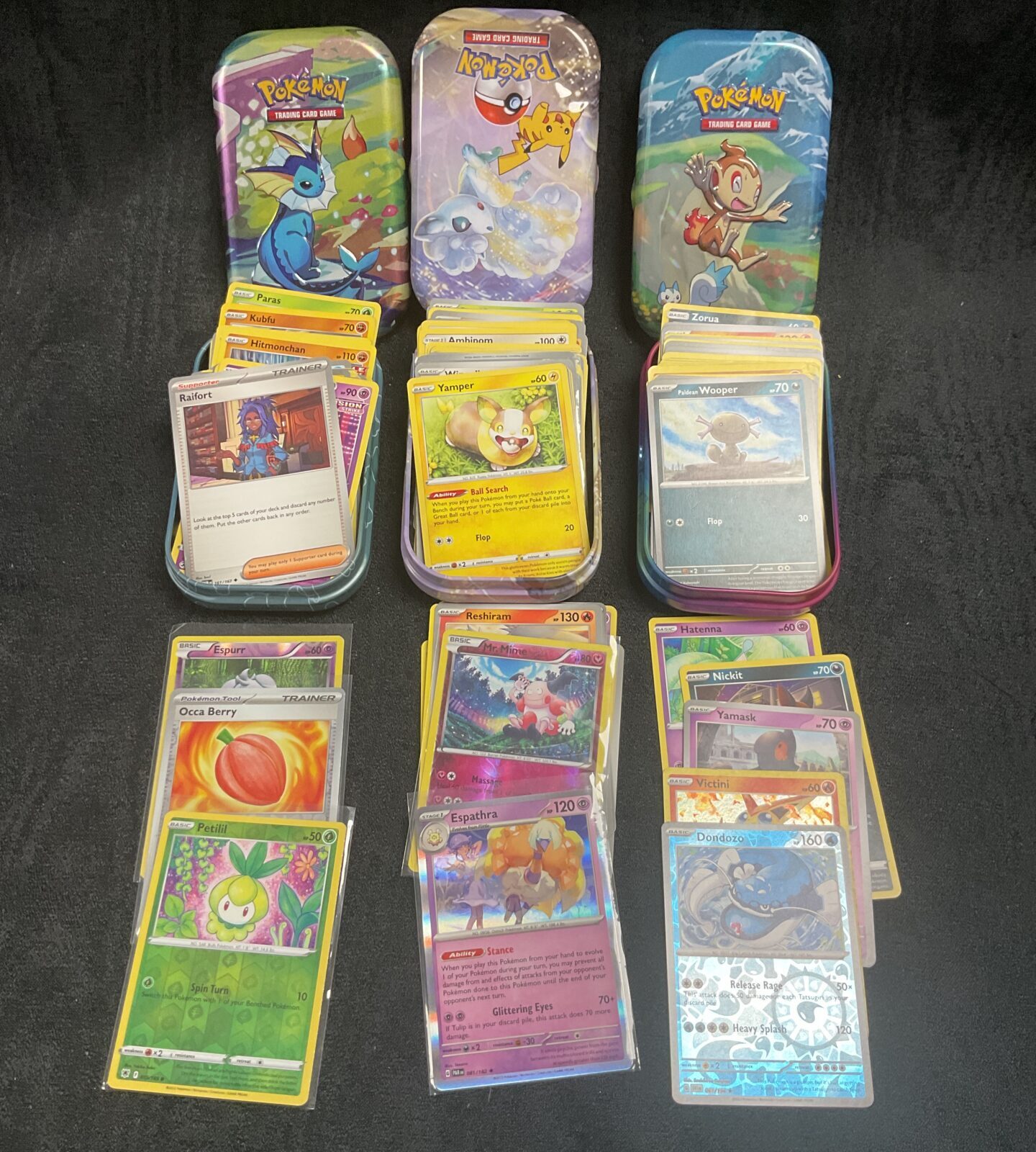 Three tins Pokemon cards