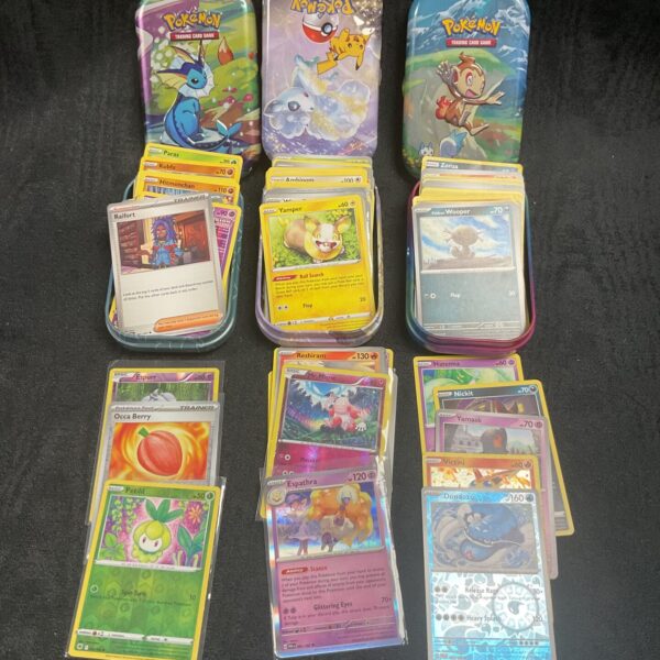 Three tins Pokemon cards
