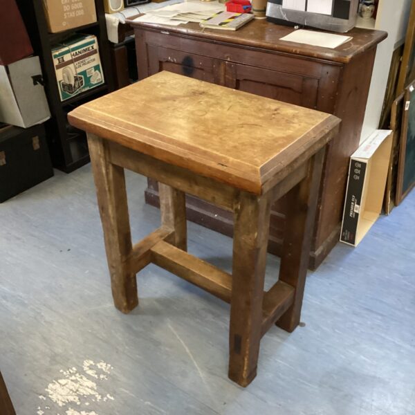 Vintage butchers block table with a worn wooden surface.