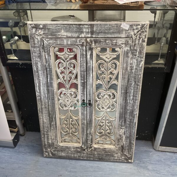 Front view of a shabby chic carved window mirror with a distressed finish.