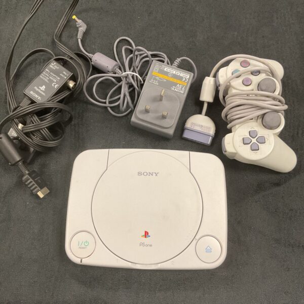 Sony PS1 Slim console with controller and power plug for retro gaming.