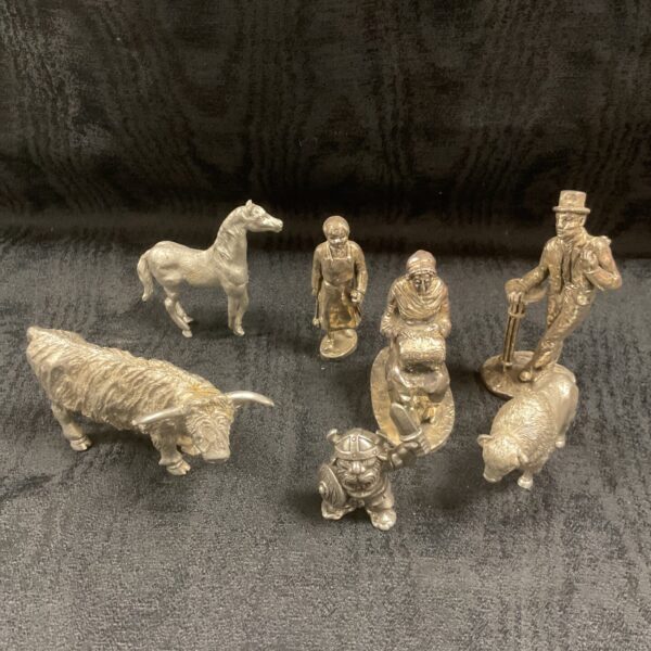 Vintage cast metal figures of a bull and bison.