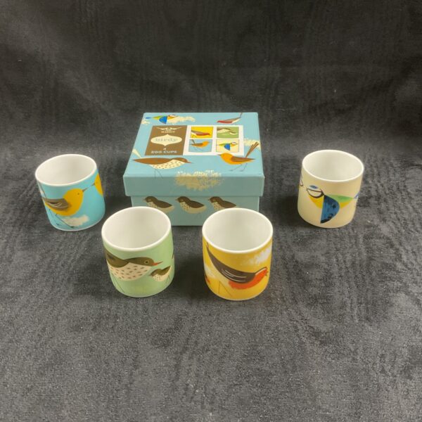 Set of four Birdy magpie egg cups on a white surface.