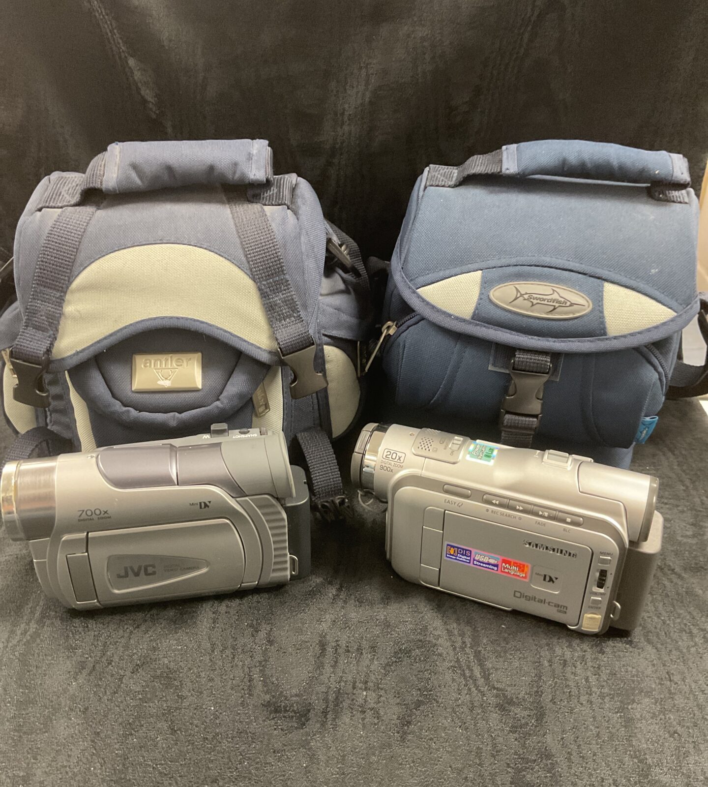 JVC and Samsung digital camcorders in bags with accessories
