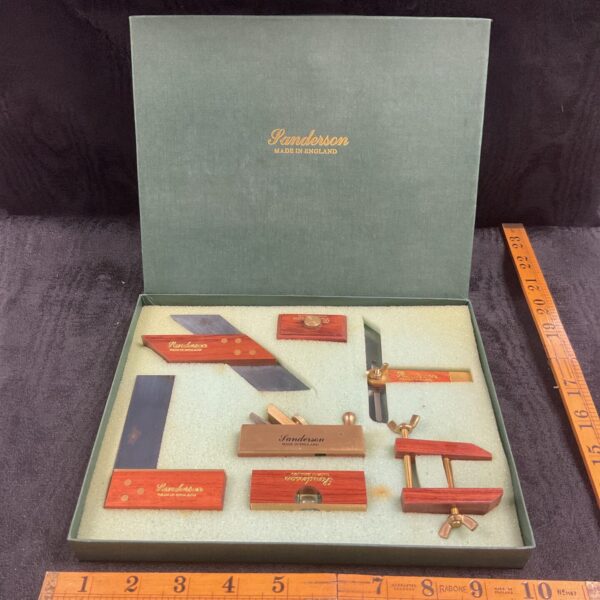 Vintage Sanderson mini woodworking tool set displayed in its original presentation box.