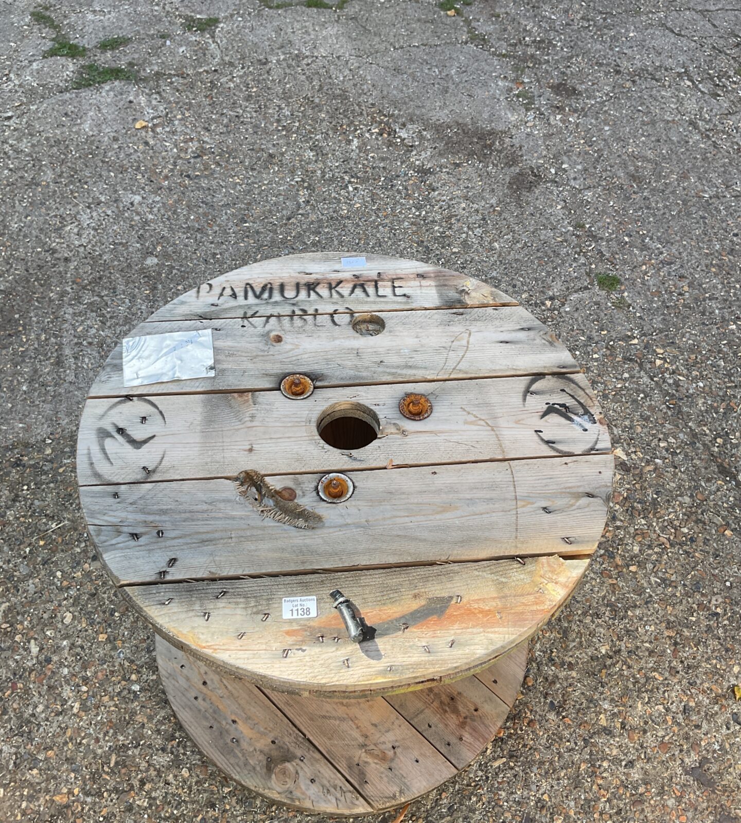 Large wooden cable drum, weathered industrial spool for repurposing.