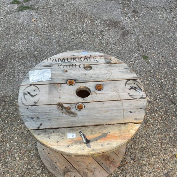 Large wooden cable drum, weathered industrial spool for repurposing.