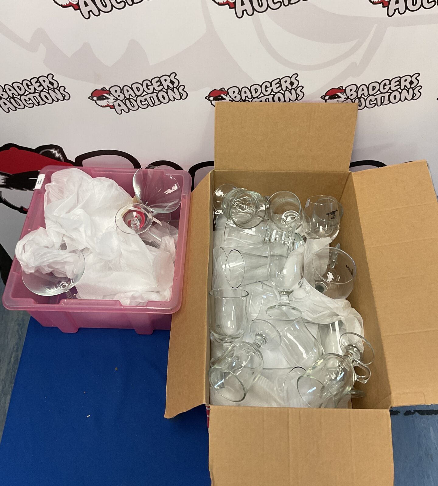 Two boxes filled with a mixed lot of glassware, including cocktail glasses.