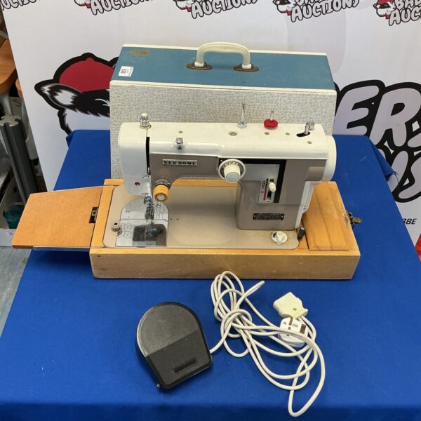 Vintage New Home sewing machine with carrying case.