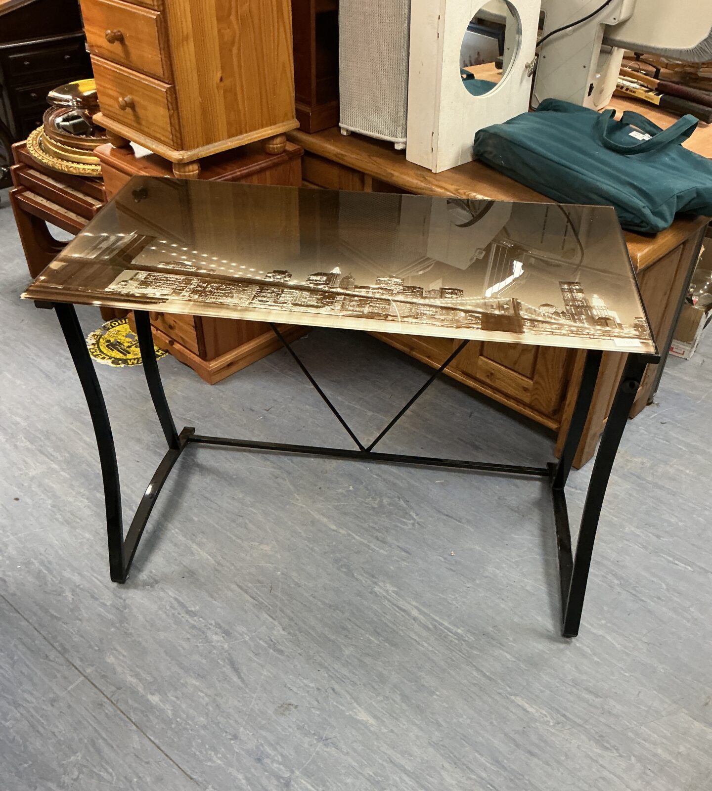 Modern glass top table with New York skyline design.