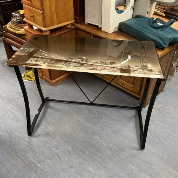 Modern glass top table with New York skyline design.