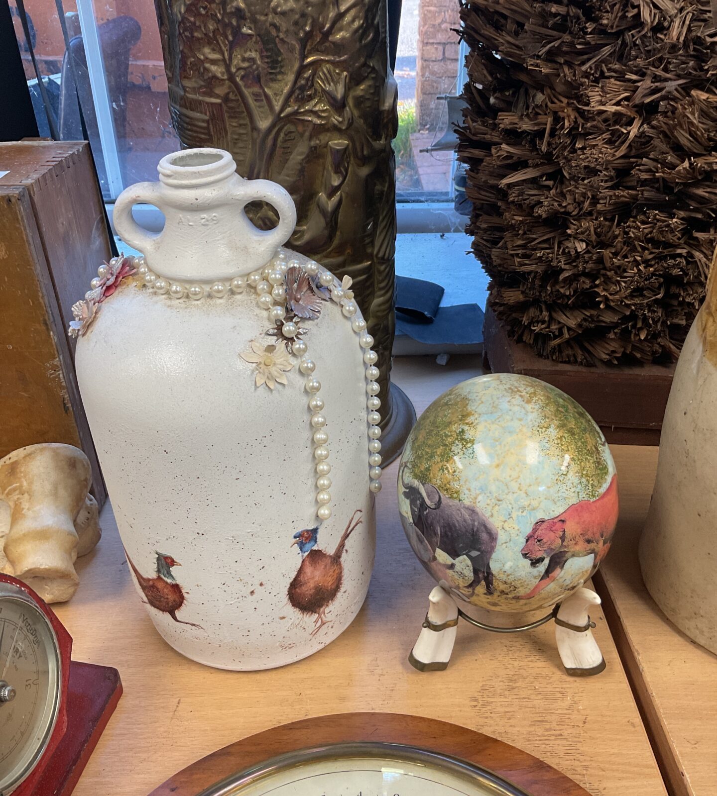 Signed ostrich egg on pedestal with pheasant flagon, collectible art.