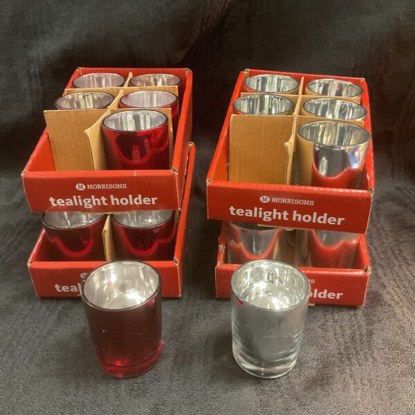 Bulk lot of red and silver glass tea light holders.