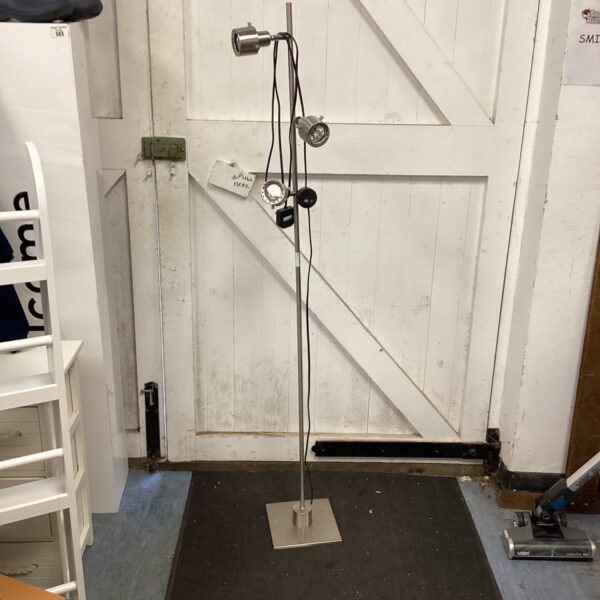 Sleek stainless steel standard lamp with adjustable LED head.
