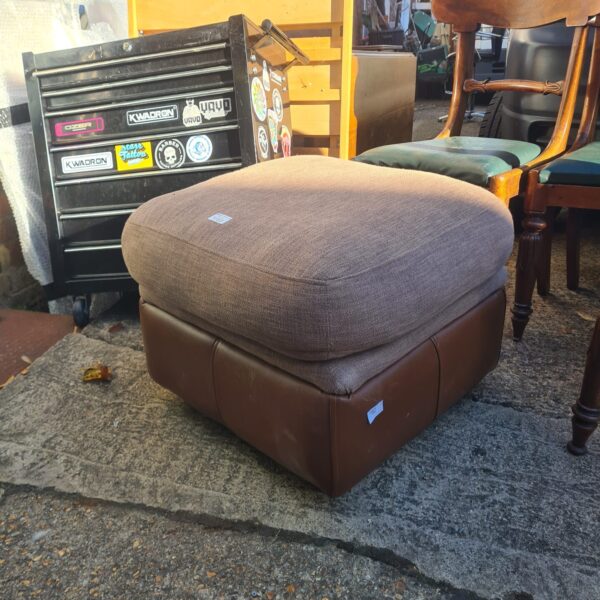 Brown leather Thomas Lloyd ottoman with storage capacity.
