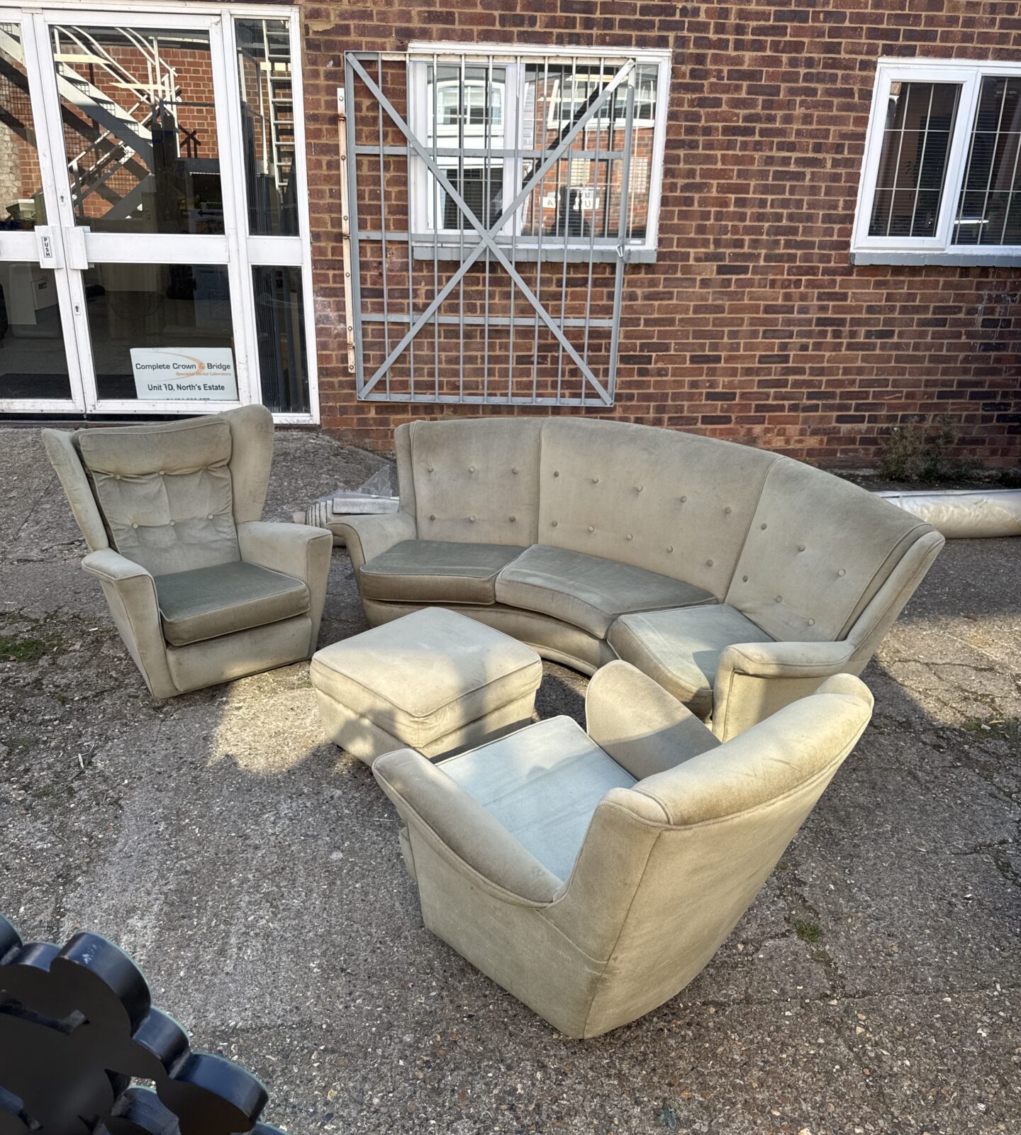 Yellow vintage banana sofa set with matching chairs and pouffe.