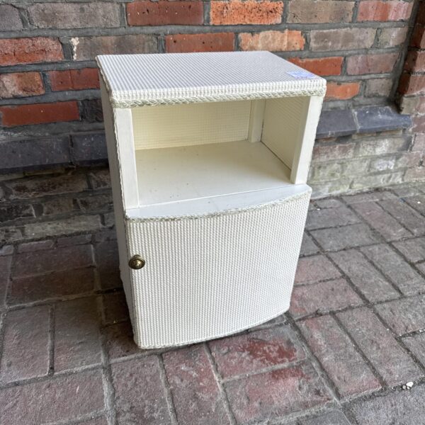Vintage loom bedside cabinet with woven texture and single door.