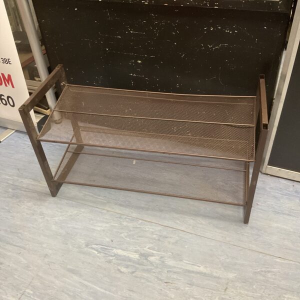 Vintage metal shoe rack with three tiers for shoe storage.