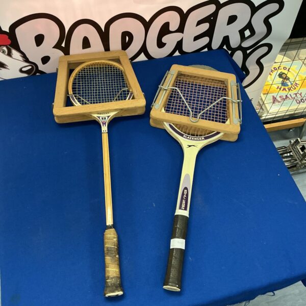 Pair of vintage wooden sports rackets for tennis or similar sports.
