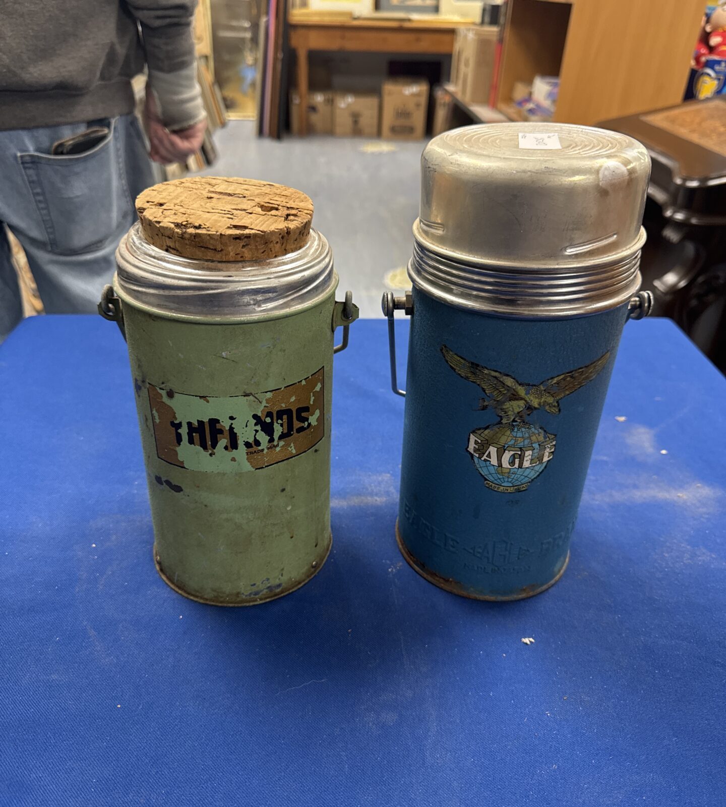 Pair of vintage metal thermos flasks, blue and green.